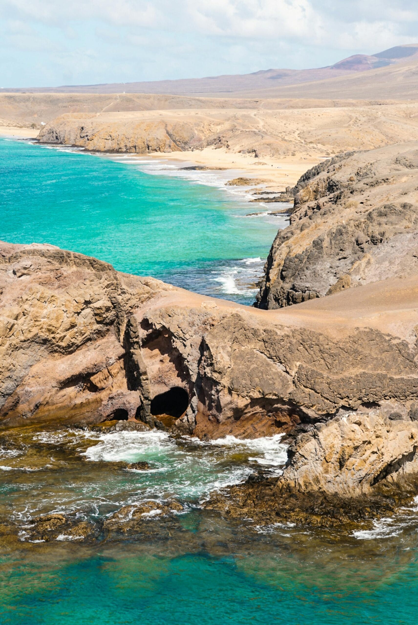 Dramatic rocky coastline of Yaiza, Lanzarote, with turquoise waters and unique geological formations.