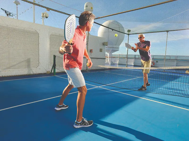Guests playing paddle tennis on the sports deck of Oceania Nautica