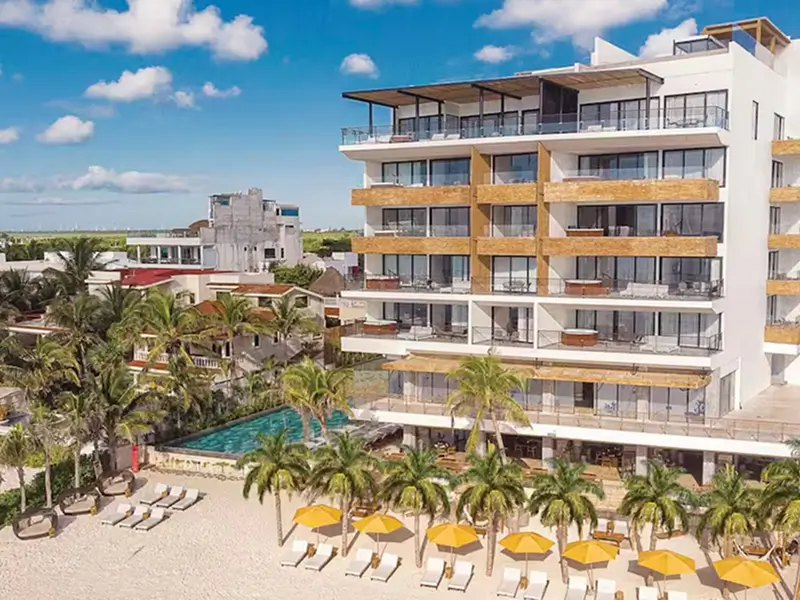 4-star The Fives Oceanfront resort exterior with Caribbean Sea beachfront and infinity pool in Puerto Morelos Riviera Maya Mexico