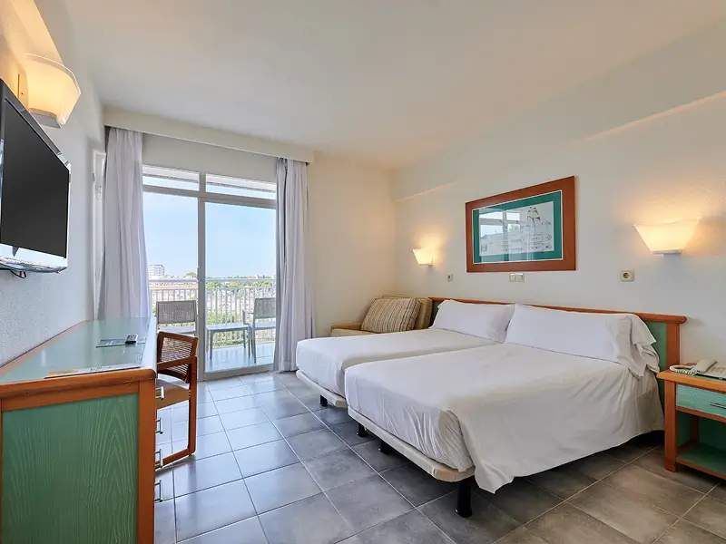 Comfortable guest bedroom at AluaSun Cala Antena